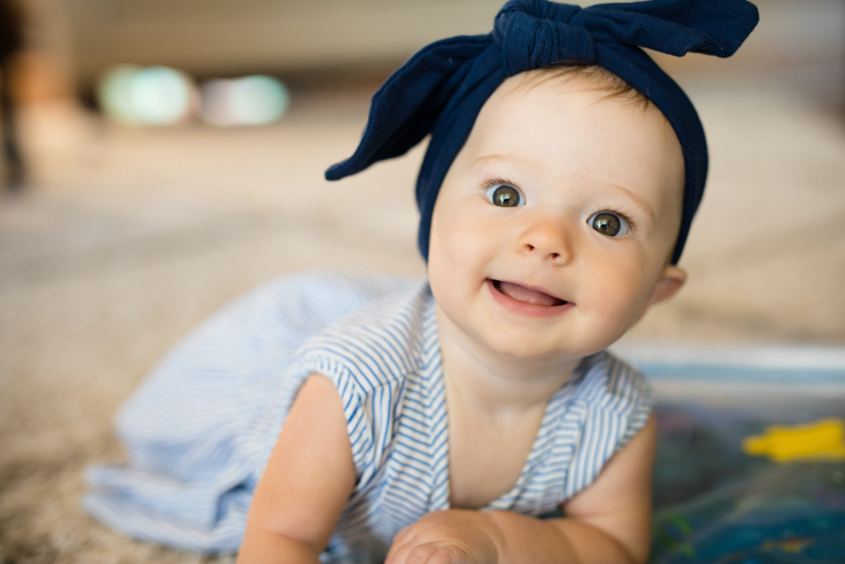baby girl in bow smiling